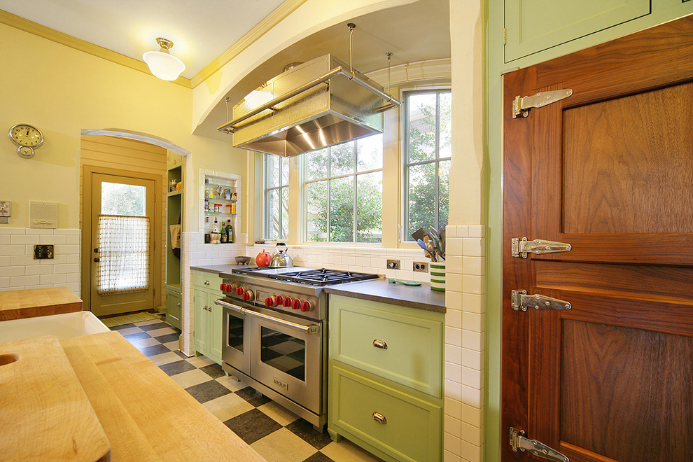 This is an example of a traditional kitchen in Dallas with stainless steel appliances and green cabinets.