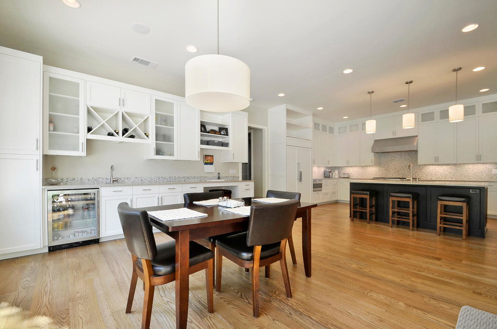 Contemporary eat-in kitchen in Austin with white cabinets and panelled appliances.