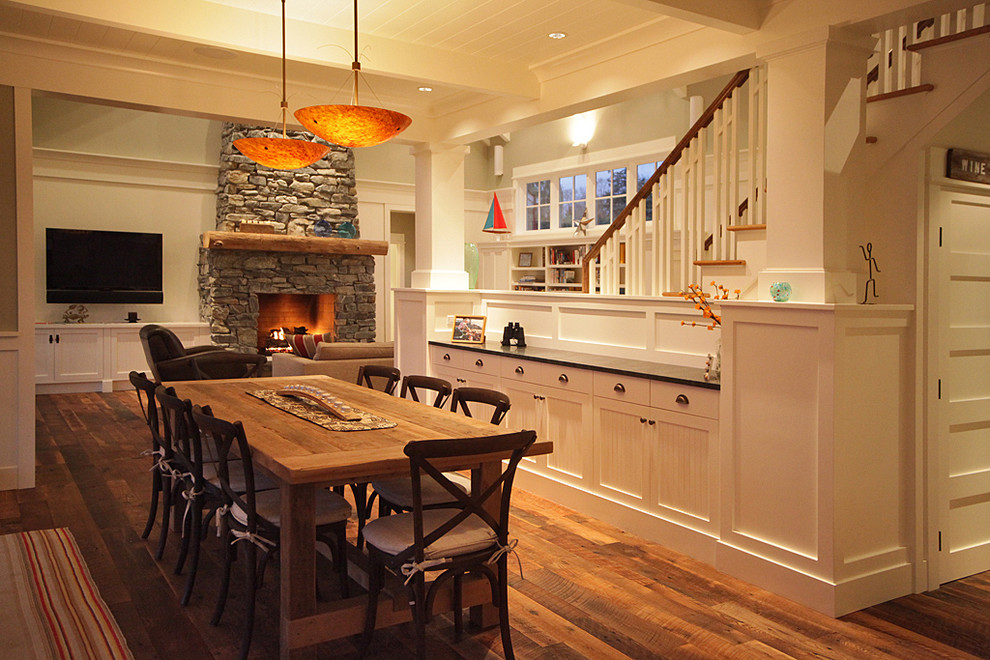 Design ideas for a country dining room in Seattle with a stone fireplace surround.