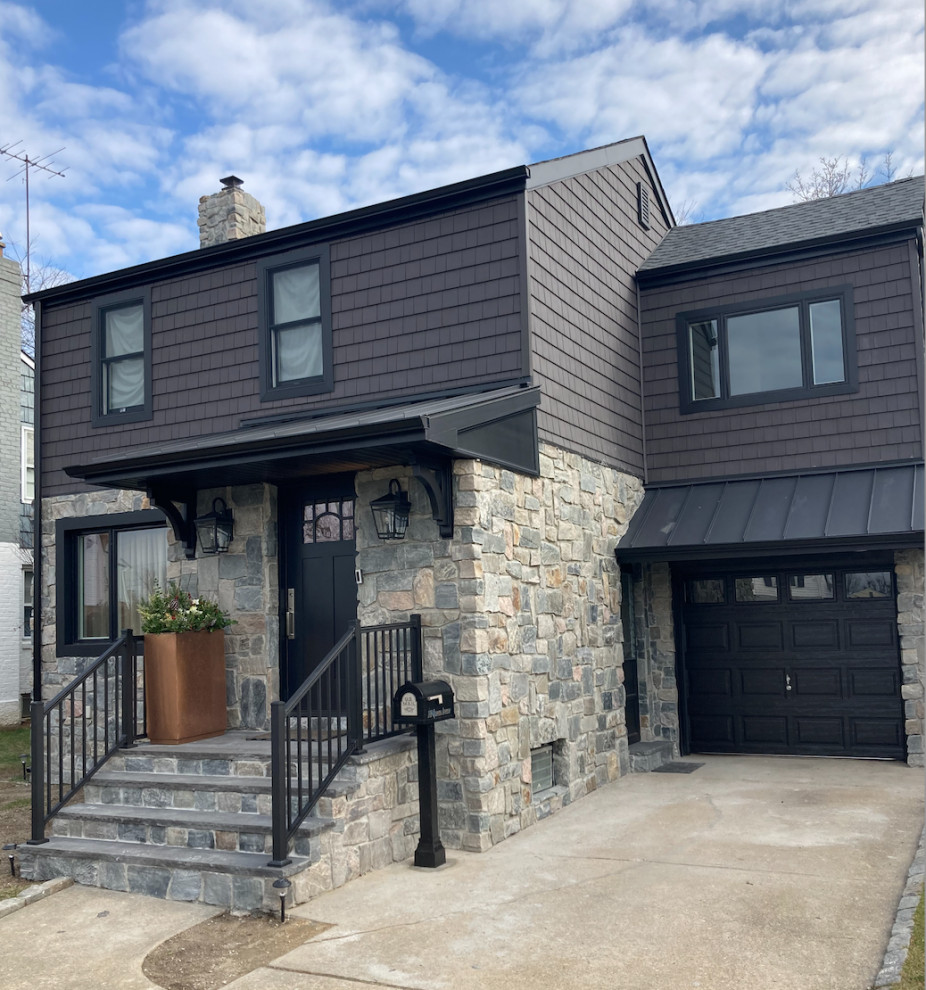 This is an example of a country two-storey black exterior in New York with vinyl siding, a metal roof, a black roof and shingle siding.