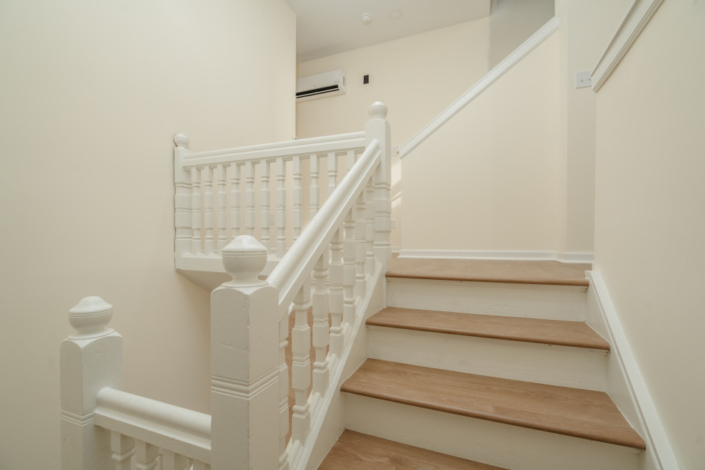 Inspiration for a large arts and crafts wood u-shaped staircase in DC Metro with wood risers and wood railing.