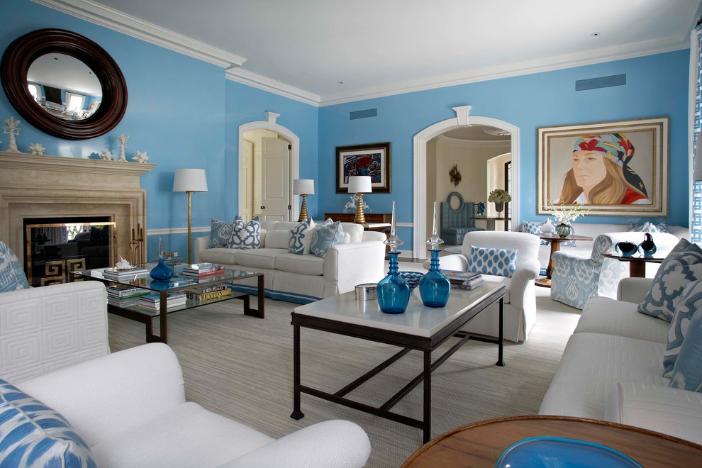 Example of a beach style enclosed living room library design in Miami with black walls, a standard fireplace and no tv