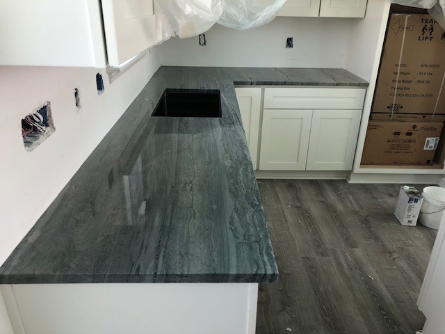 Example of a large beach style l-shaped enclosed kitchen design in Raleigh with an undermount sink, quartzite countertops, stainless steel appliances, an island and blue countertops