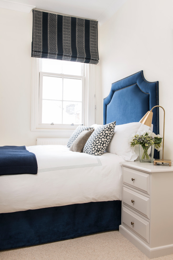 Design ideas for a transitional bedroom in London with white walls.