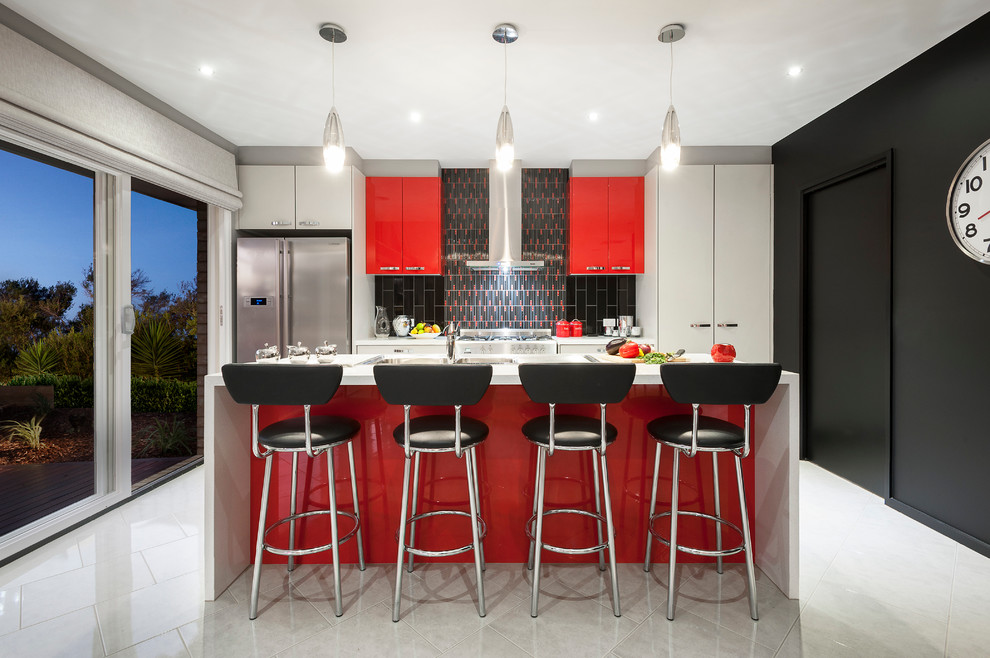 Photo of a small modern galley eat-in kitchen in Sydney with a double-bowl sink, flat-panel cabinets, red cabinets, quartz benchtops, black splashback, mosaic tile splashback, stainless steel appliances, ceramic floors and with island.