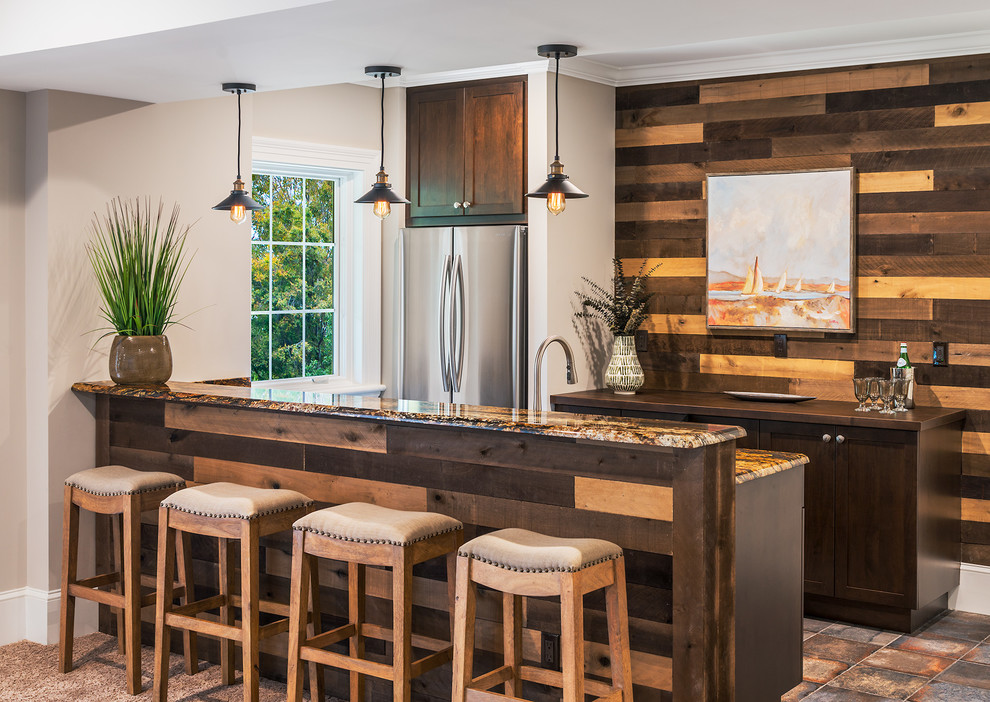 This is an example of a small transitional single-wall seated home bar in DC Metro with an undermount sink, shaker cabinets, dark wood cabinets, granite benchtops, brown splashback, timber splashback, porcelain floors and multi-coloured floor.