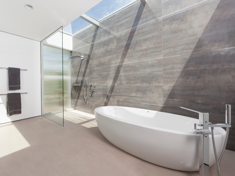 This is an example of a mid-sized modern master bathroom in San Francisco with a freestanding tub, an open shower, beige tile and grey walls.