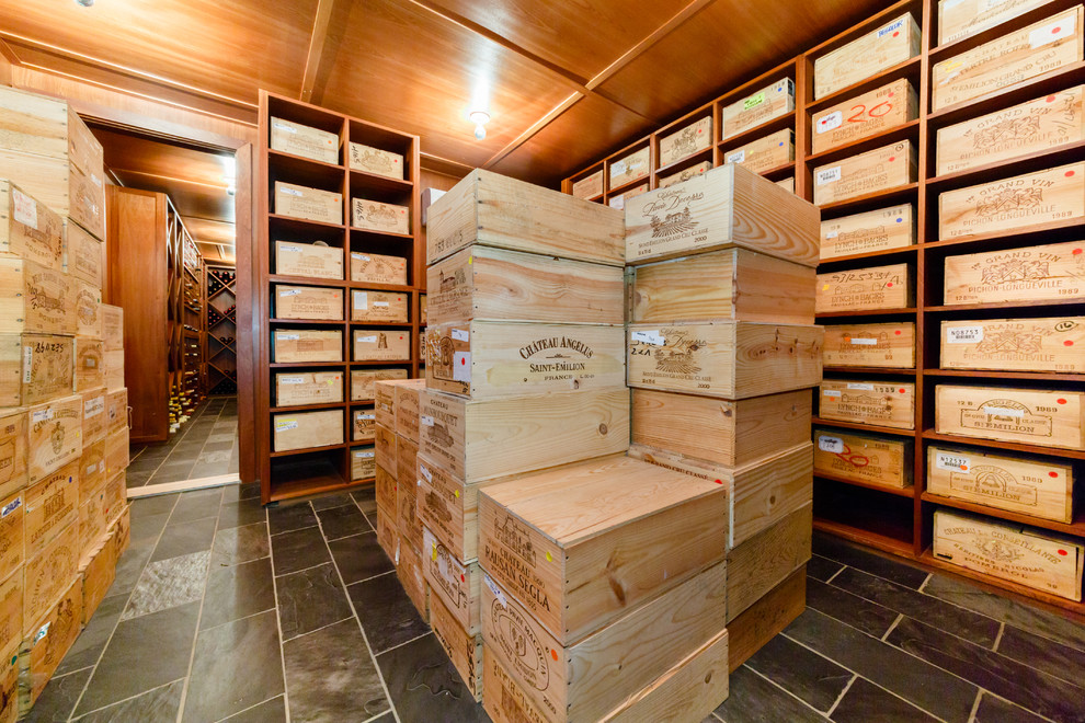 Design ideas for a large contemporary wine cellar in New York with slate floors, storage racks and black floor.