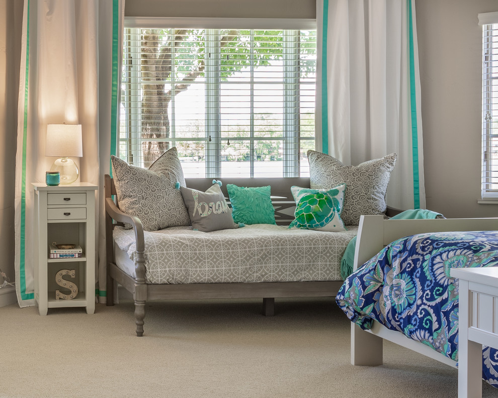 This is an example of a mid-sized beach style guest bedroom in Denver with beige walls, carpet and grey floor.