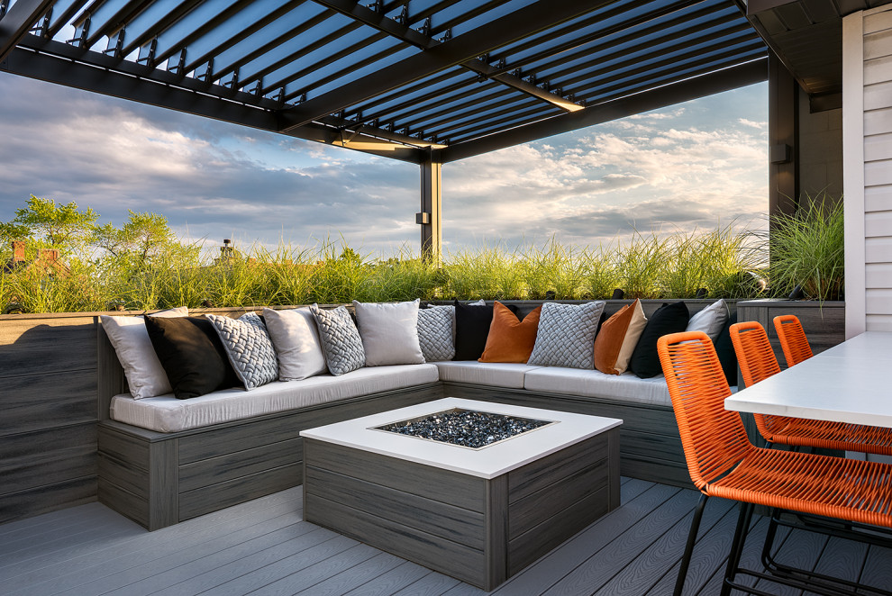 Inspiration for an expansive modern rooftop deck in Chicago with with fireplace and a pergola.
