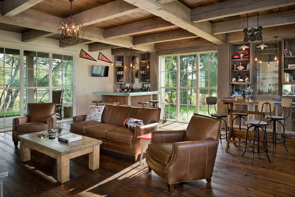Country family room in Other with a home bar and brown floor.