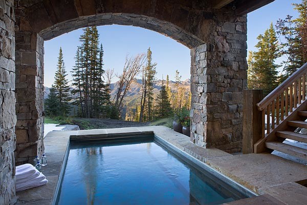 Example of a mountain style rectangular and stone aboveground pool design