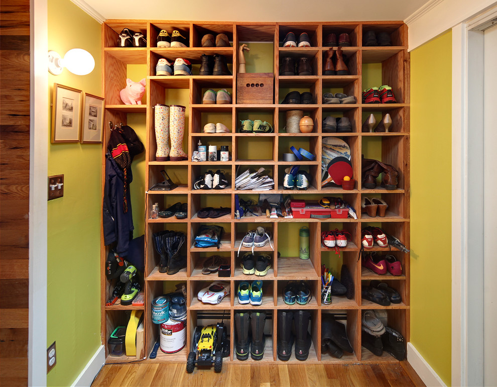 Photo of a small contemporary mudroom in Boston with green walls, medium hardwood floors and a single front door.