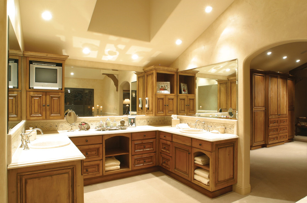 Mediterranean bathroom in Los Angeles with medium wood cabinets and raised-panel cabinets.