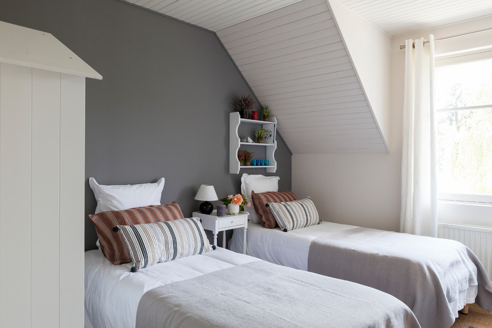 Photo of a small farmhouse guest bedroom in Other with grey walls.