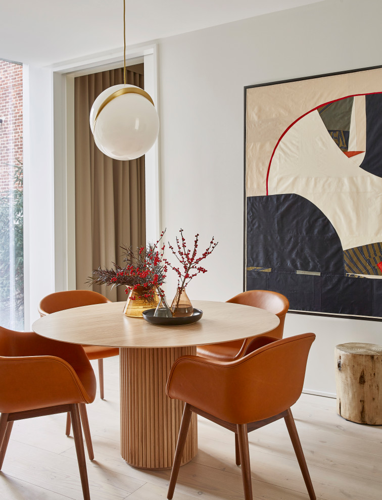 This is an example of a mid-sized contemporary open plan dining in New York with white walls, light hardwood floors, no fireplace and beige floor.