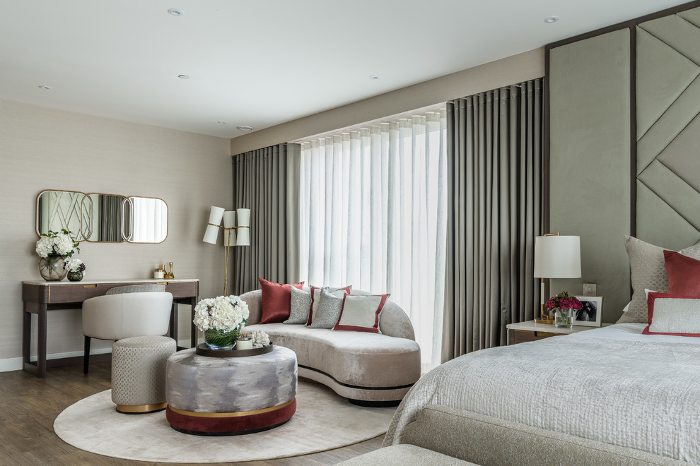 Large contemporary master bedroom in London with no fireplace, beige walls and dark hardwood floors.