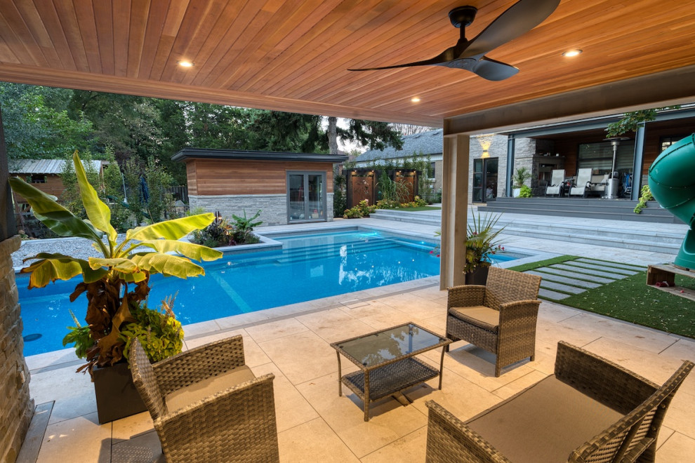 This is an example of a large modern backyard rectangular pool in Toronto with with a pool.