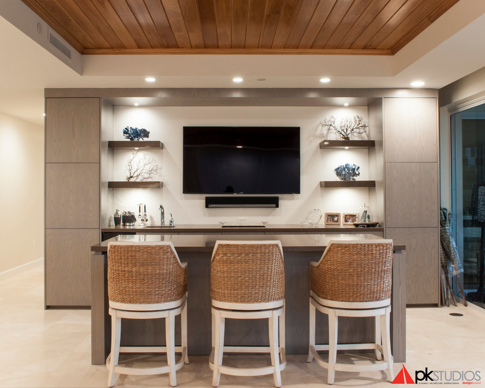 Photo of a mid-sized contemporary single-wall wet bar in Miami with flat-panel cabinets, travertine floors, an undermount sink, medium wood cabinets and solid surface benchtops.