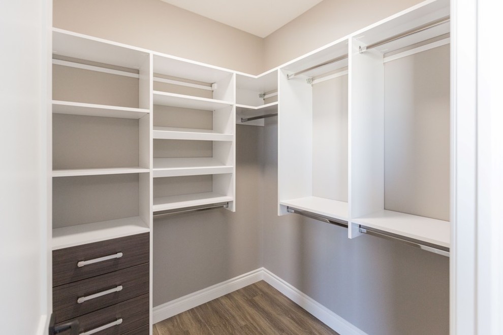 Design ideas for a small transitional gender-neutral walk-in wardrobe in Other with flat-panel cabinets, medium wood cabinets and laminate floors.
