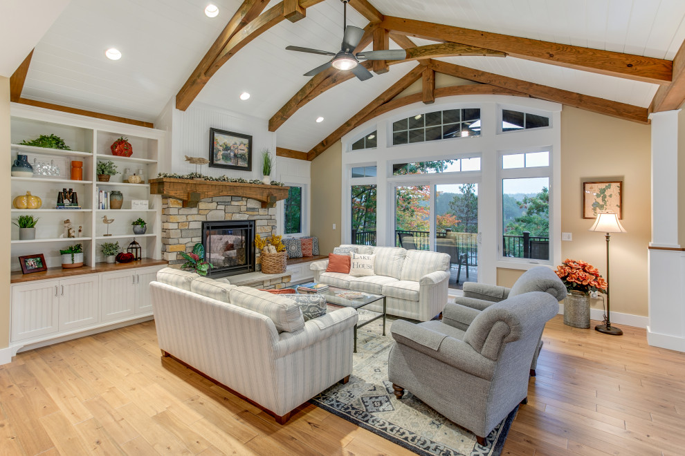 Design ideas for a transitional formal open concept living room in Other with beige walls, medium hardwood floors, a standard fireplace, a stone fireplace surround, no tv, brown floor, exposed beam, timber and vaulted.