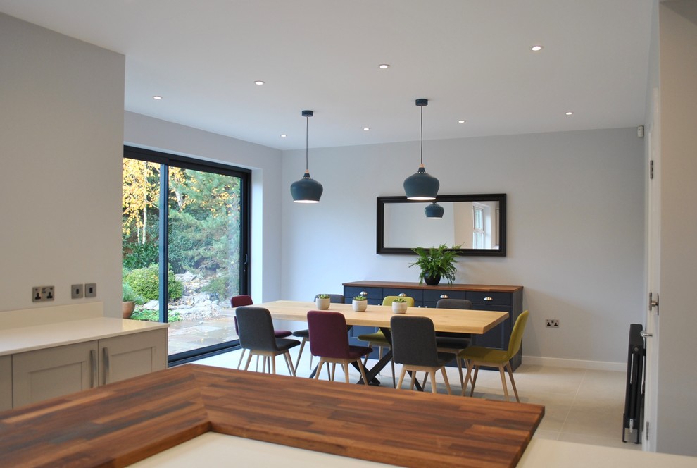 Design ideas for a large scandinavian kitchen/dining combo in Hertfordshire with grey walls, porcelain floors and grey floor.
