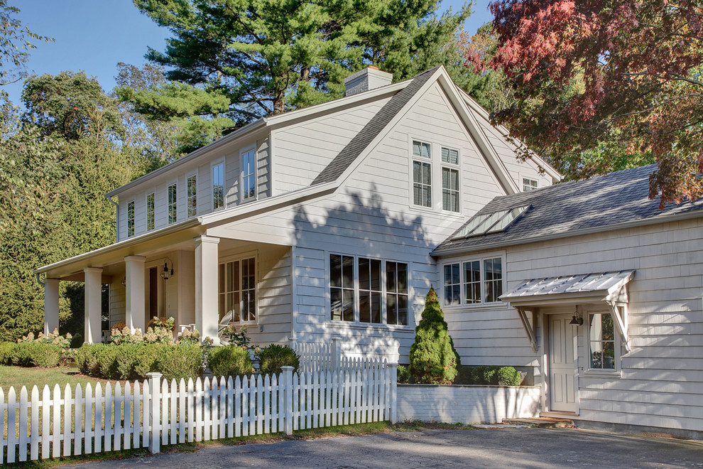 Inspiration for a mid-sized traditional two-storey white exterior in New York with wood siding and a gable roof.