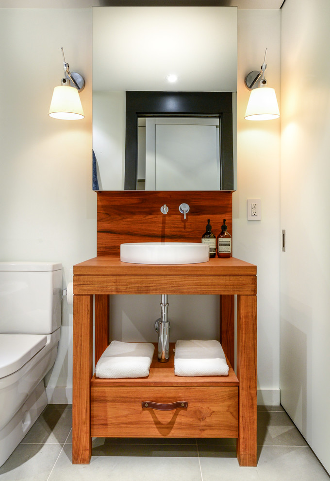 Small transitional powder room in Vancouver with a vessel sink.