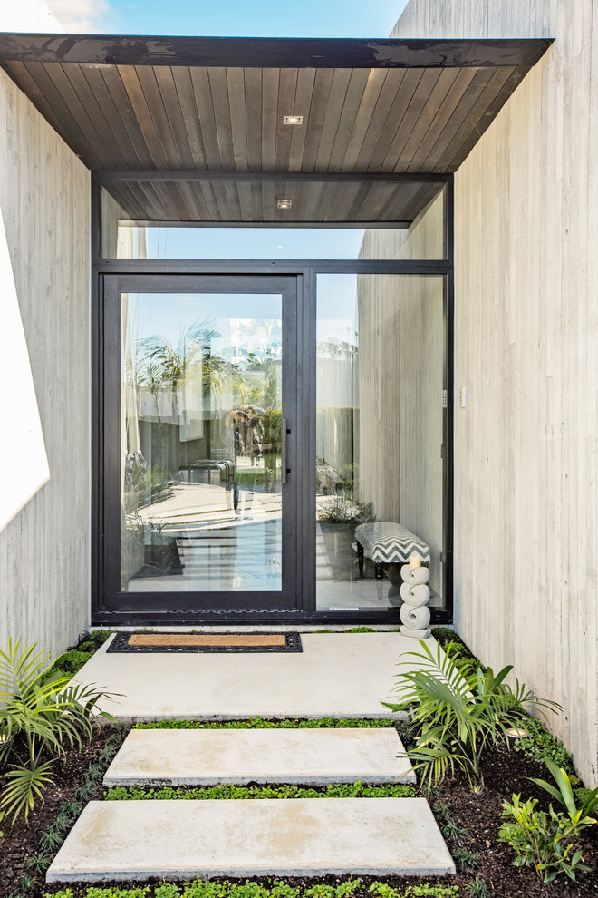 Photo of a contemporary front door in Auckland with beige walls, a single front door and a glass front door.
