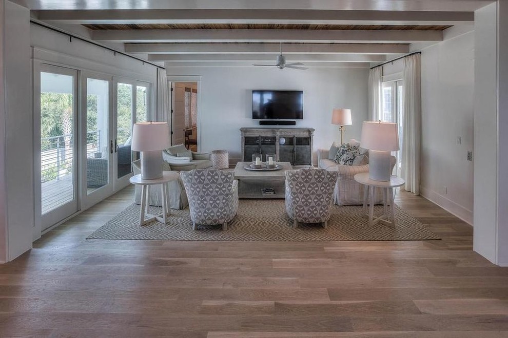Design ideas for a mid-sized country formal open concept living room in Miami with white walls, light hardwood floors, no fireplace, a wall-mounted tv and beige floor.