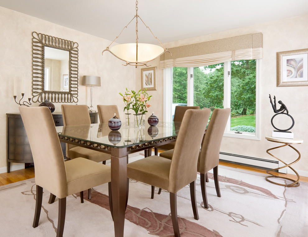 This is an example of a transitional dining room in Boston with beige walls and medium hardwood floors.