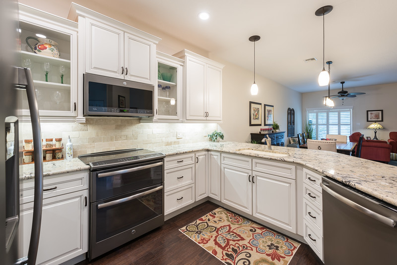 Eat-in kitchen - transitional u-shaped eat-in kitchen idea in Orlando with flat-panel cabinets and no island