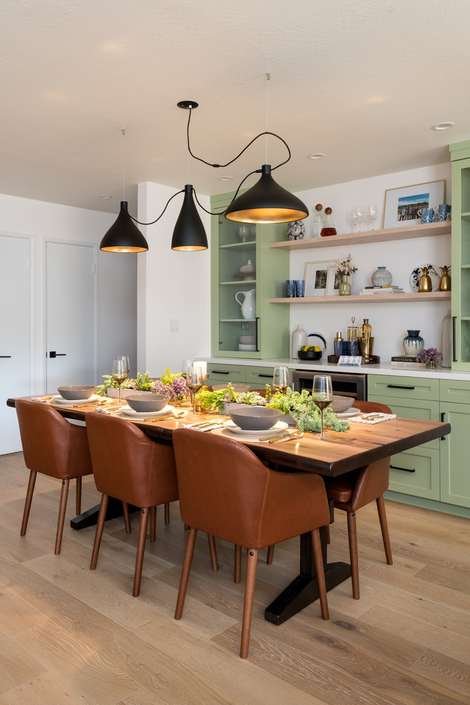 Photo of a transitional kitchen/dining combo in Other with white walls and white floor.