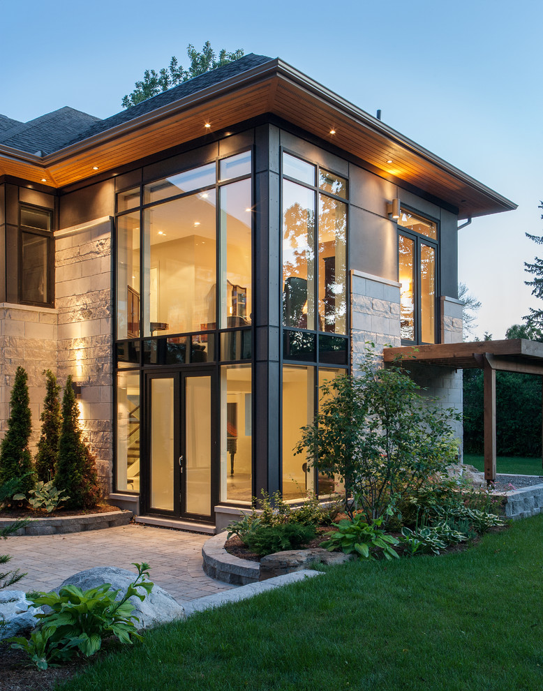 Design ideas for a contemporary two-storey grey exterior in Ottawa with stone veneer.