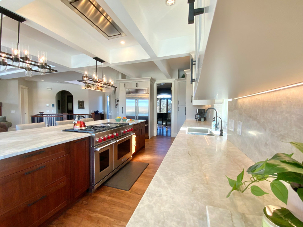 Inspiration for a large transitional single-wall dark wood floor, brown floor and coffered ceiling eat-in kitchen remodel in Calgary with an undermount sink, shaker cabinets, quartzite countertops, stainless steel appliances, an island and white cabinets