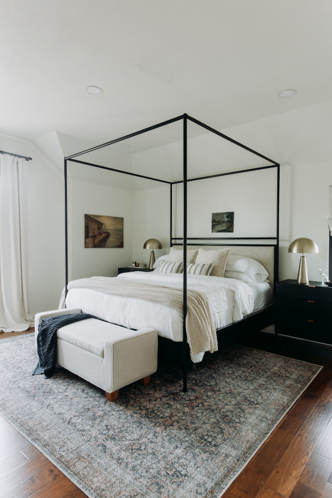 Example of a transitional master medium tone wood floor bedroom design in Dallas with white walls
