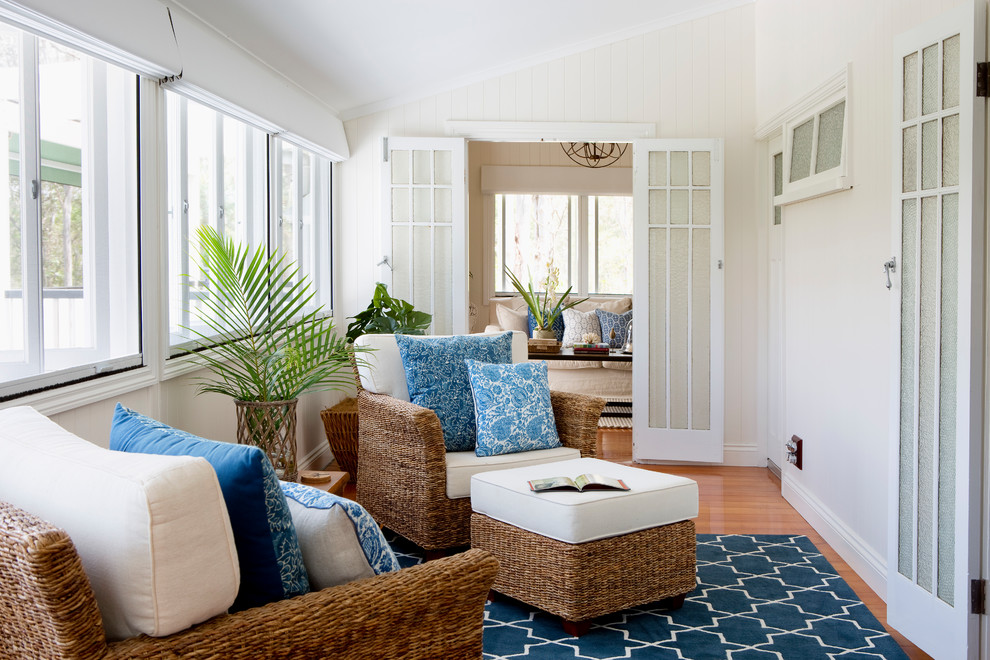 Inspiration for a beach style sunroom in Brisbane with medium hardwood floors and brown floor.