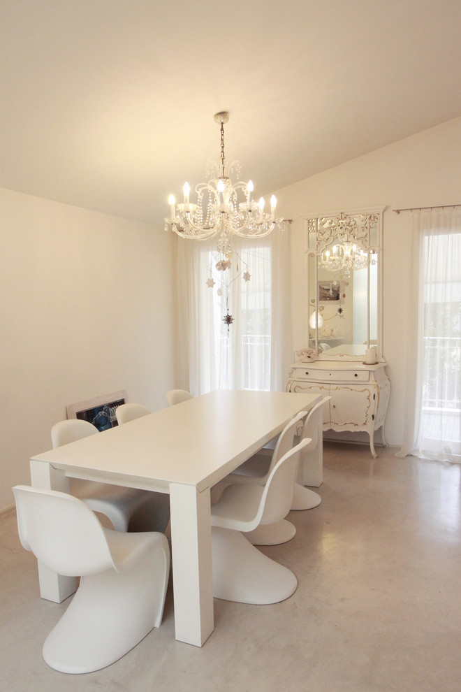 Photo of a large traditional dining room in Bologna with white walls and porcelain floors.