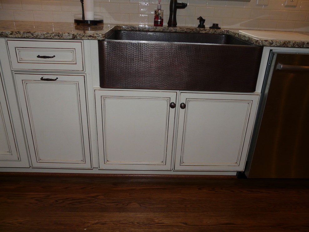 Transitional eat-in kitchen photo in Birmingham with a farmhouse sink, flat-panel cabinets, granite countertops, porcelain backsplash and stainless steel appliances