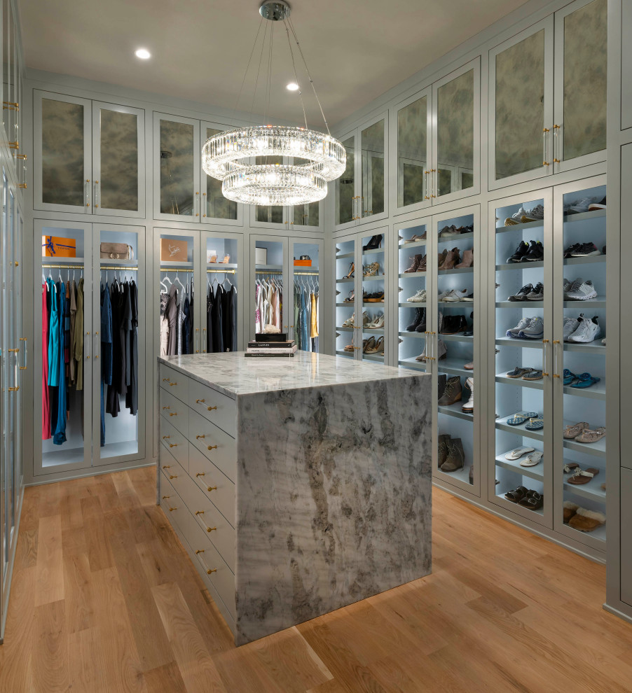 Photo of a large contemporary gender-neutral walk-in wardrobe in Dallas with shaker cabinets, grey cabinets, light hardwood floors and beige floor.