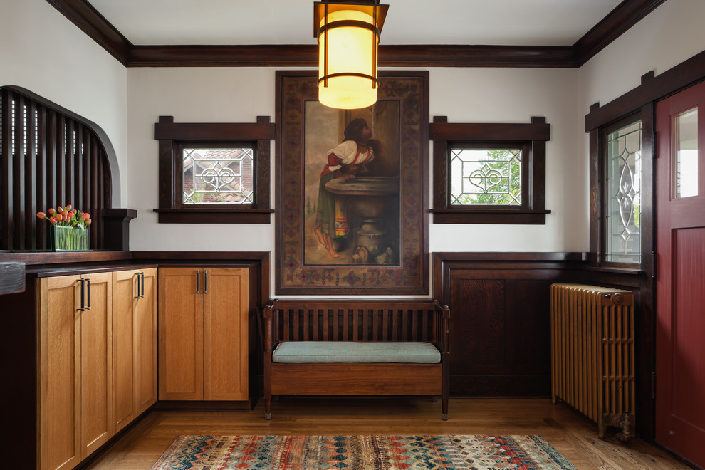 Photo of a mid-sized arts and crafts foyer in Seattle with white walls, medium hardwood floors, a single front door and a red front door.