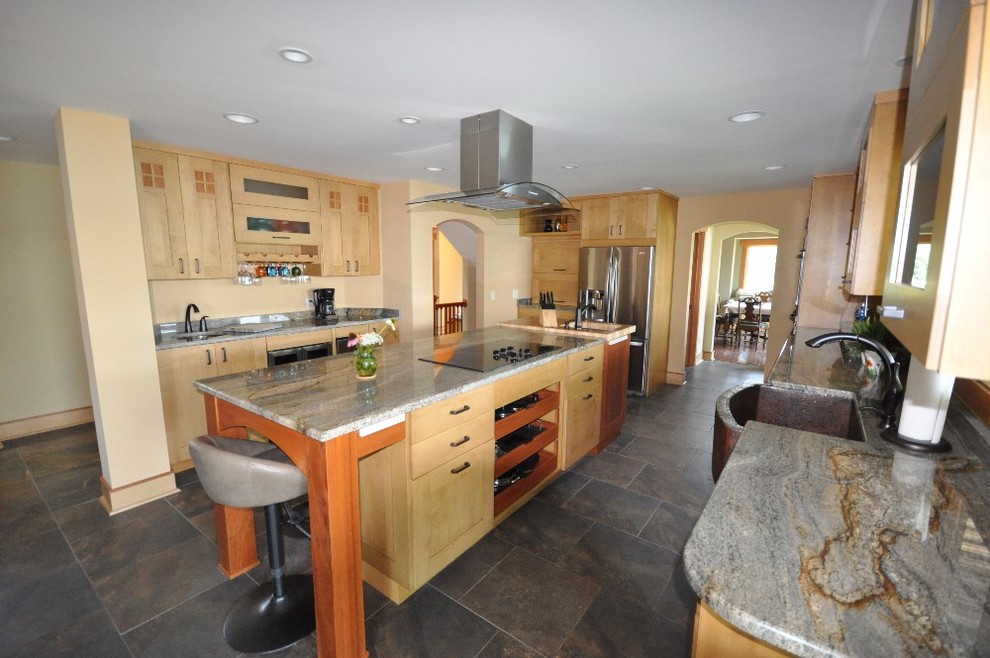 Example of a mid-sized classic u-shaped ceramic tile eat-in kitchen design with a drop-in sink, flat-panel cabinets, light wood cabinets, granite countertops, stainless steel appliances and an island
