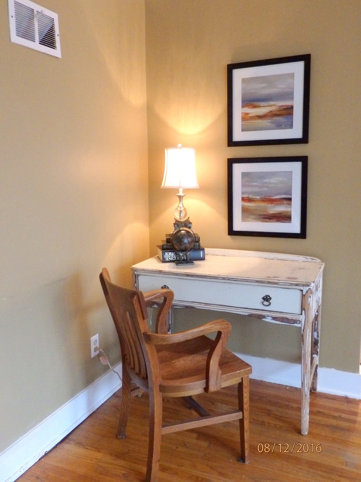 This is an example of a small eclectic enclosed living room in Toronto with brown walls, medium hardwood floors, no fireplace and a freestanding tv.
