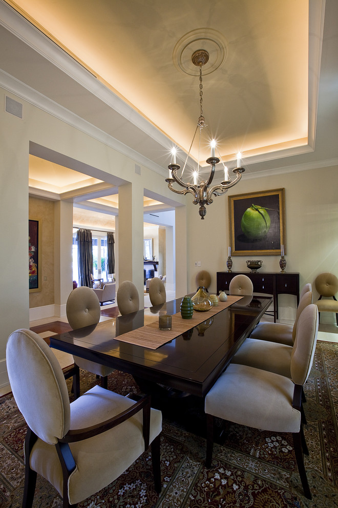 Contemporary dining room in Miami with beige walls and dark hardwood floors.