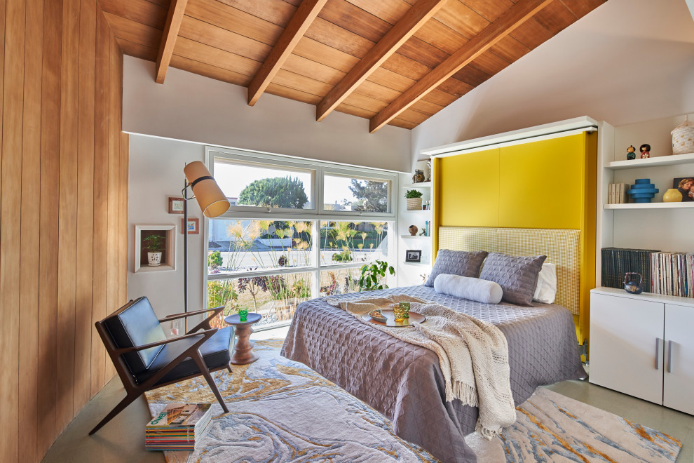 Mid-sized midcentury guest bedroom in San Diego with white walls, cork floors, grey floor, wood walls and vaulted.