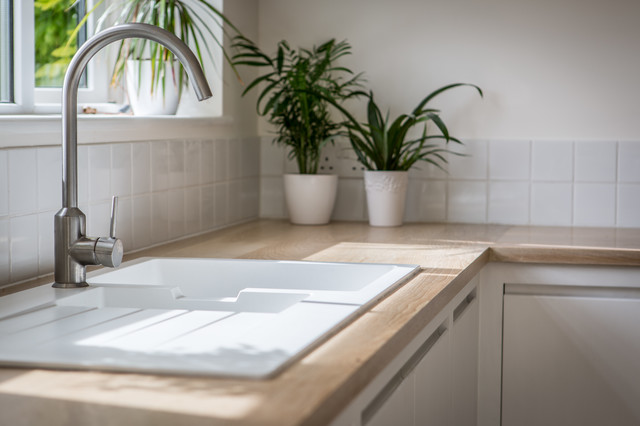 Minimalist White Kitchen with Warm Accents contemporary-kitchen