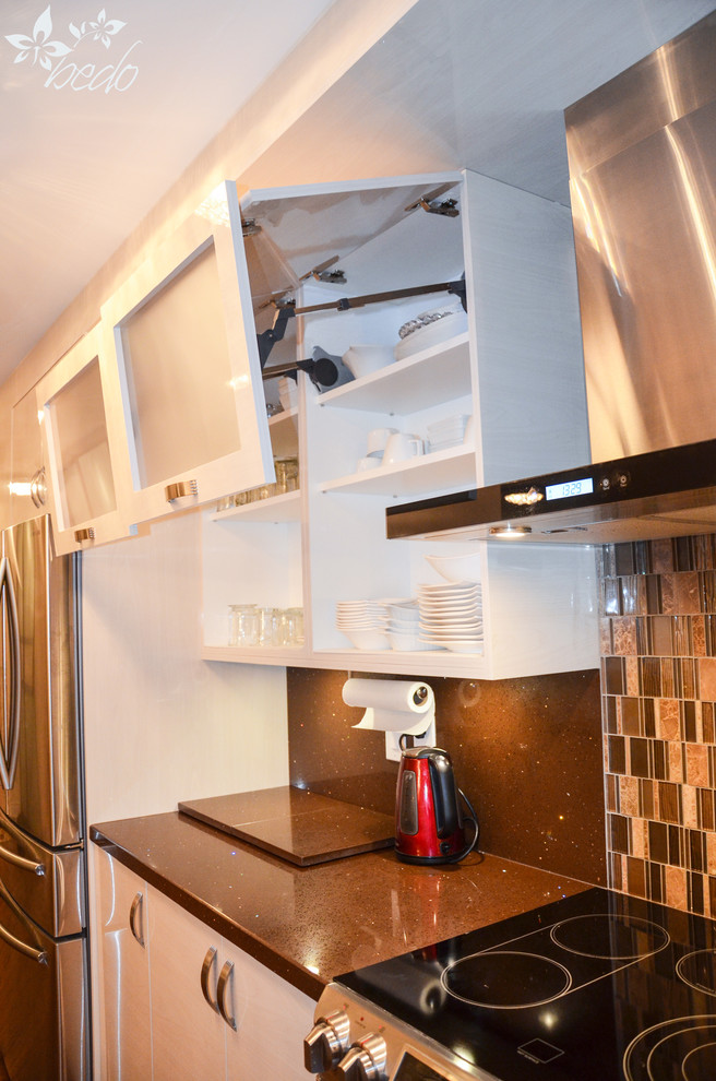 Small modern galley eat-in kitchen in Toronto with an integrated sink, flat-panel cabinets, beige cabinets, quartz benchtops, brown splashback, mosaic tile splashback, stainless steel appliances, dark hardwood floors and with island.