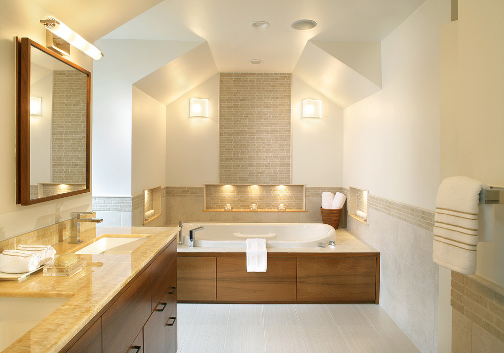 Contemporary bathroom in New York with an undermount sink, flat-panel cabinets, medium wood cabinets and a drop-in tub.