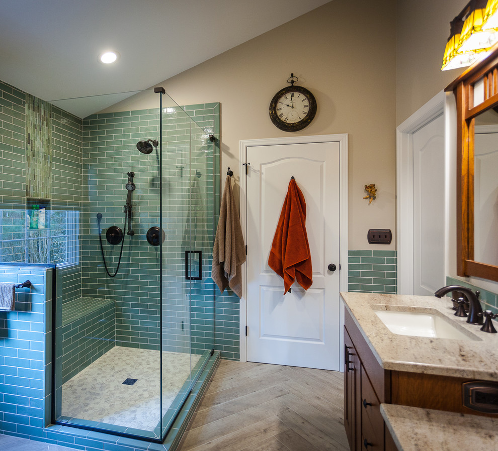 Design ideas for a large transitional master bathroom in Raleigh with furniture-like cabinets, brown cabinets, a corner shower, a two-piece toilet, green tile, glass tile, beige walls, ceramic floors, an undermount sink, granite benchtops, beige floor, a hinged shower door and yellow benchtops.