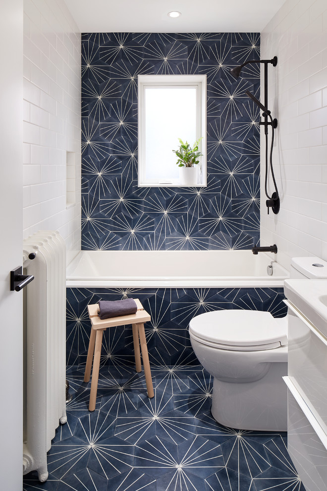 Inspiration for a contemporary bathroom in Toronto with flat-panel cabinets, white cabinets, a drop-in tub, a one-piece toilet, blue tile, cement tile, white walls, cement tiles, blue floor, a shower/bathtub combo and a console sink.